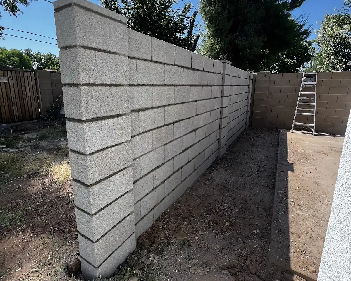 A freshly built block wall with a capped end, by our featured contractor
